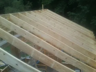 New roof rafters set over an addition before sheathing in Loganton